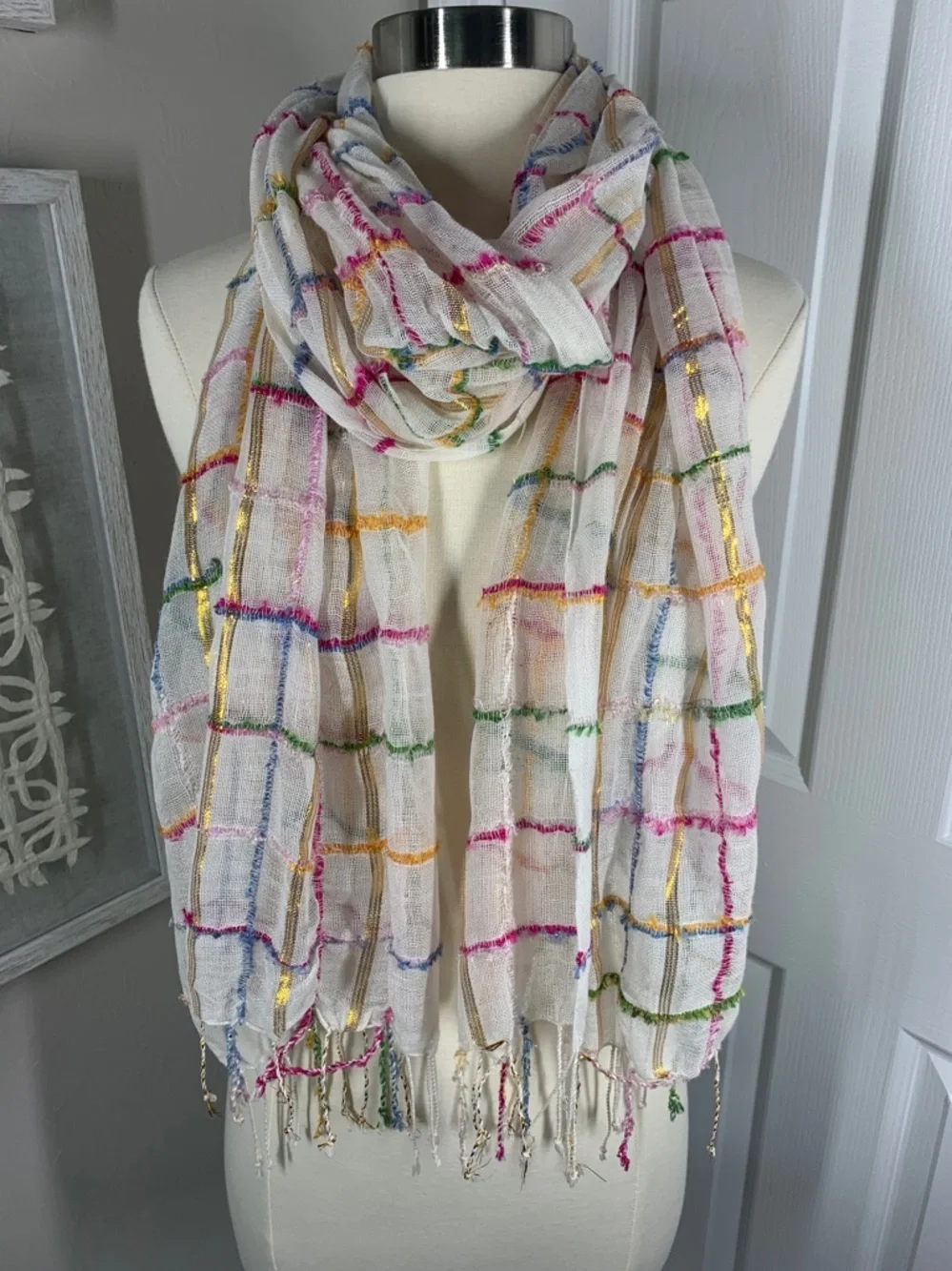 White, metallic gold, pink, blue, and green scarf with fringe
